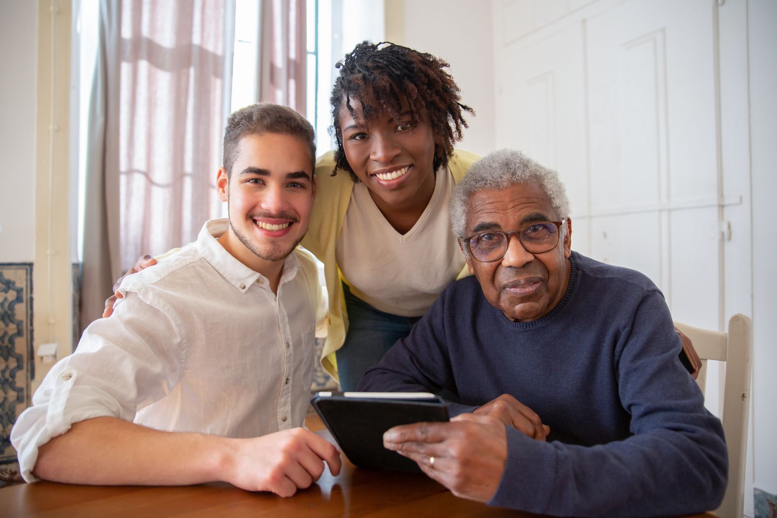 Three generations of a family together at the kitchen table of a longtime home